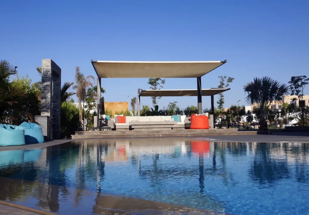 Modern residential pool with sleek design surrounded by exotic plants, offering a tranquil outdoor space in Egypt